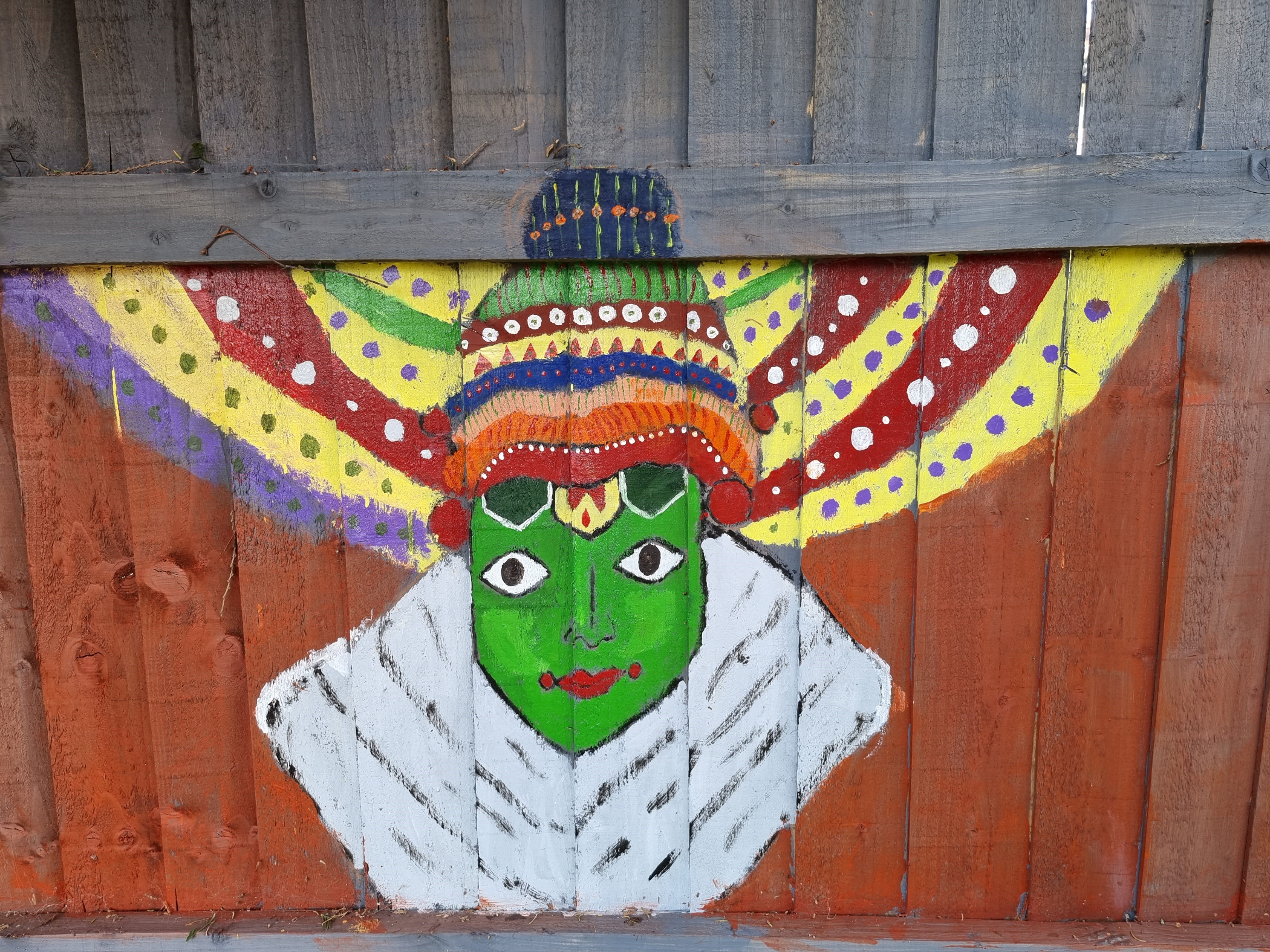 painting on fence of a traditional Kathakali dancer