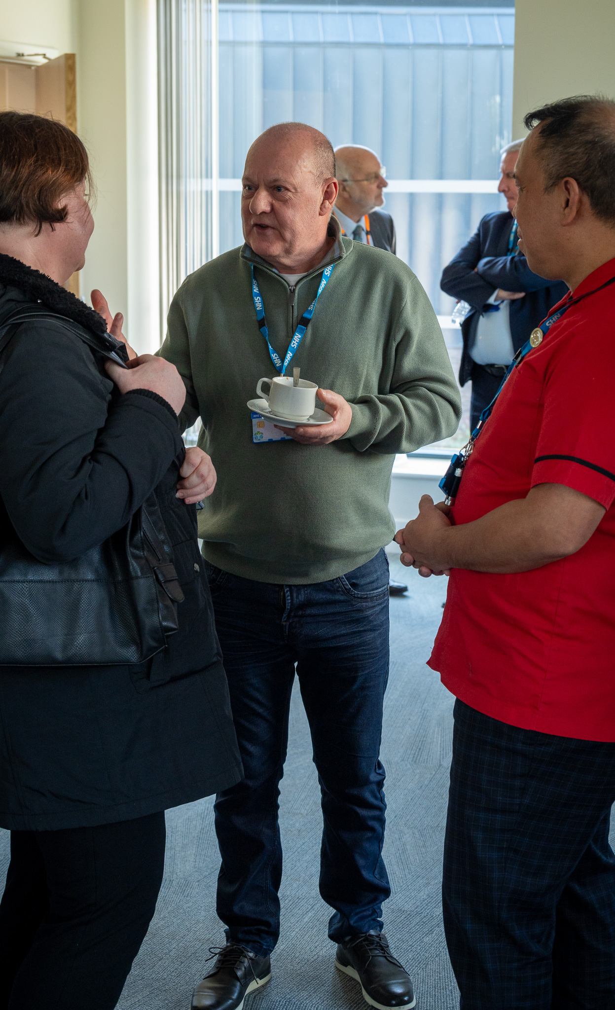 Three people standing talking 