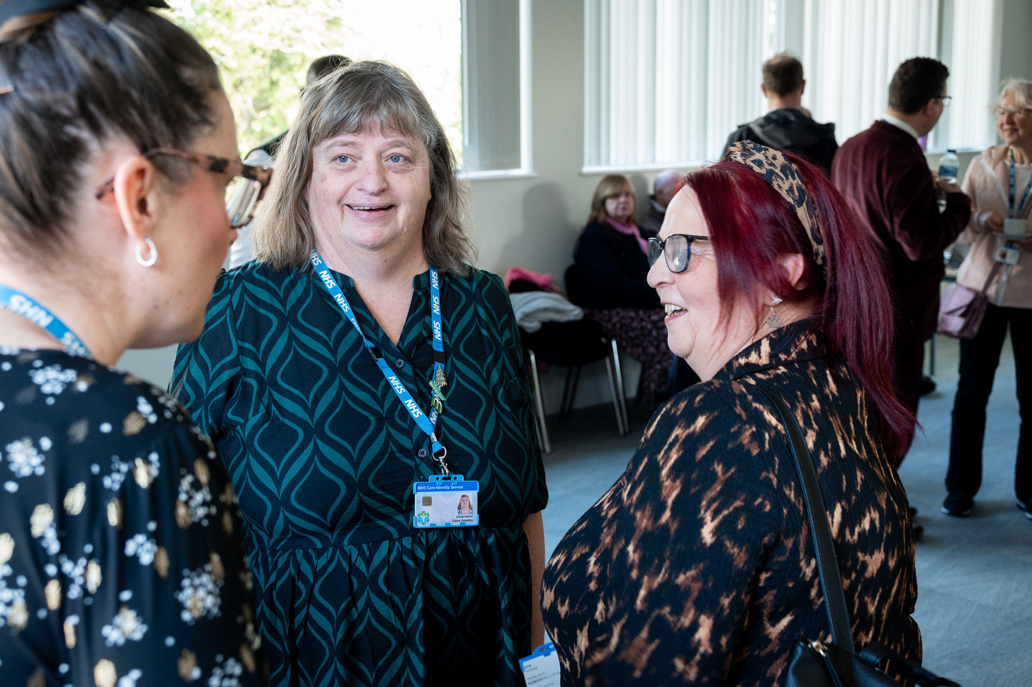 3 women laughing and talking together 