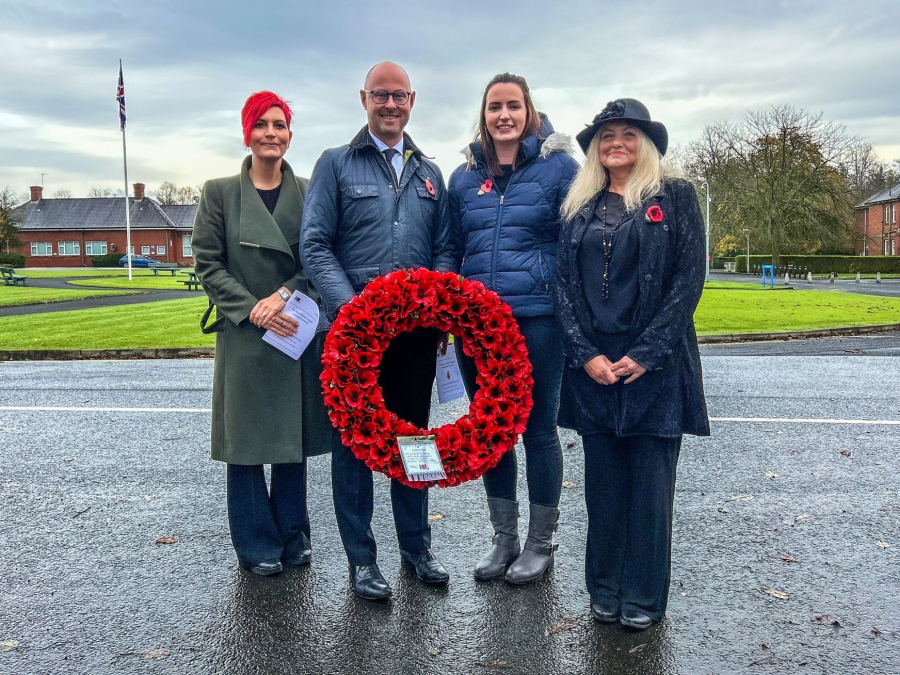 Joanna, Chris, Amy and Lesley holding poppy wreath .png